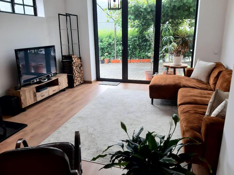 a living room with a couch and a tv at Retiro da Cava, piscina privada in Oleiros