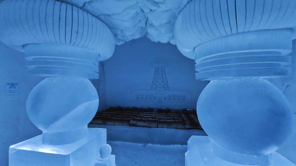 two blue vases are sitting in a room with ice at Arctic SnowHotel & Glass Igloos in Sinettä