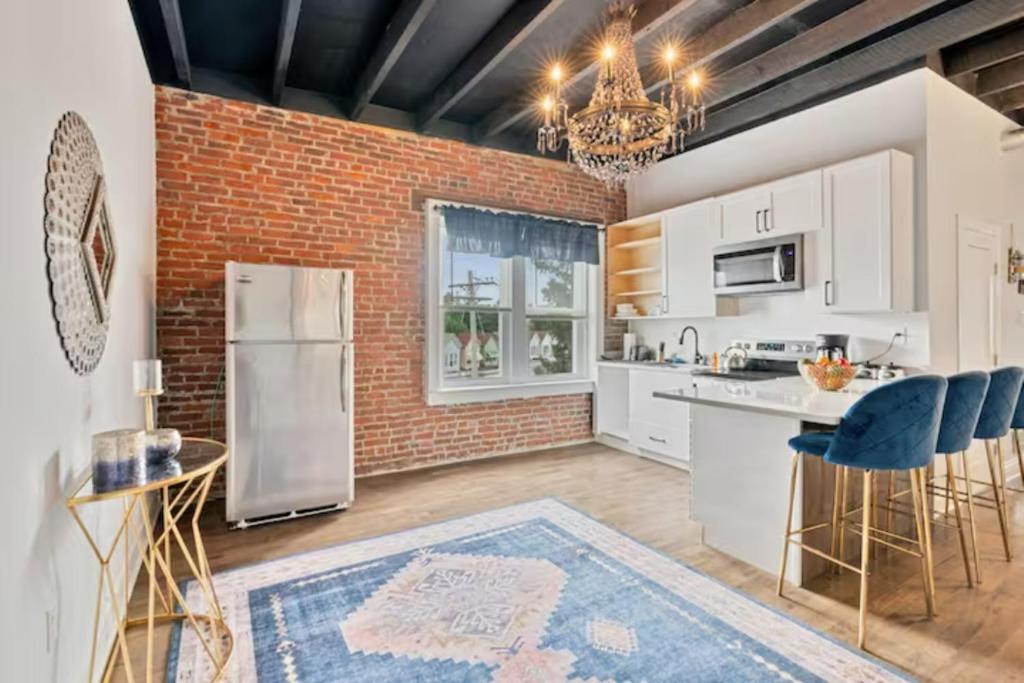 a kitchen with white appliances and a brick wall at Upscale Luxury Suites Minutes From Center City in Philadelphia