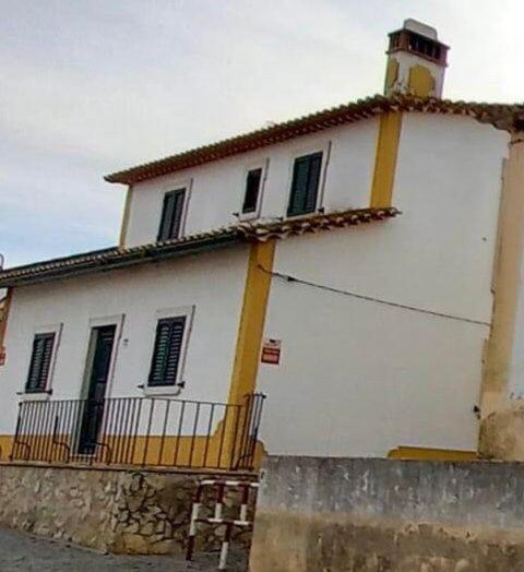 a white building with a tower with a roof at Casa da Avó Bi in Vila Nova da Barquinha