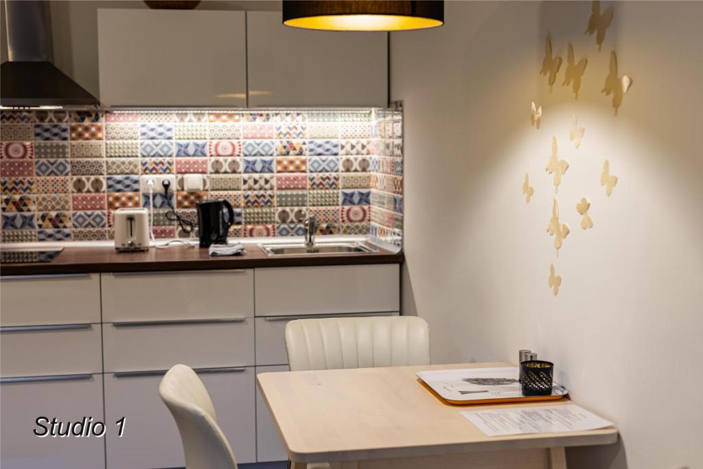 a kitchen with a table and chairs and a sink at Appartement Sportwerk in Göstling an der Ybbs