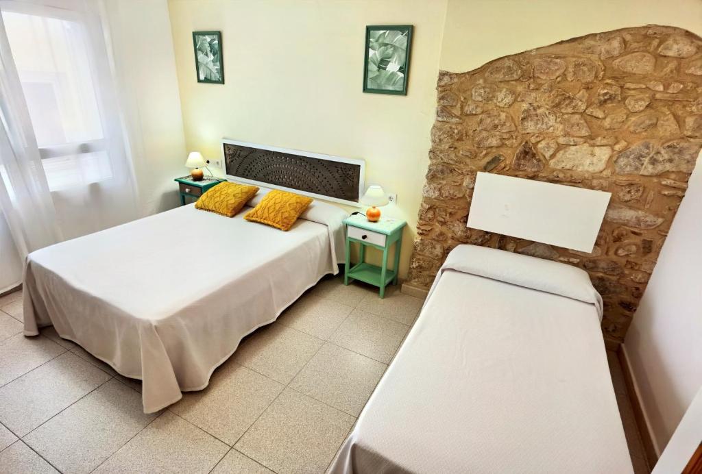 Postel nebo postele na pokoji v ubytování Hostal Noray