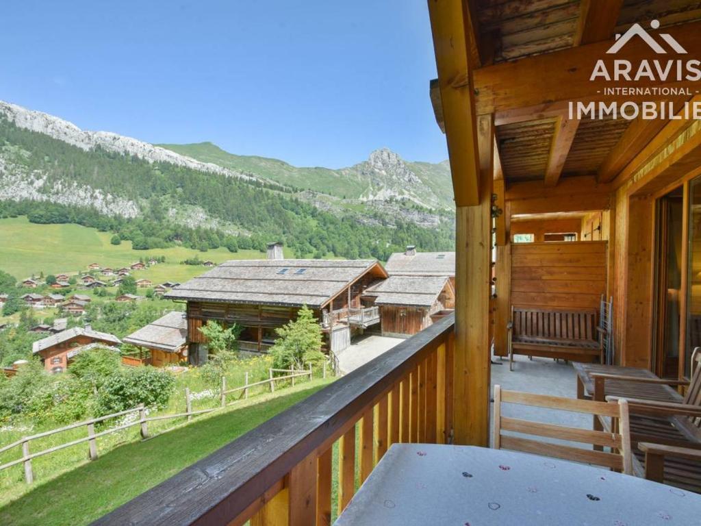 a balcony of a cabin with a table and chairs at Appartement Le Grand-Bornand, 2 pièces, 4 personnes - FR-1-391-107 in Le Grand-Bornand