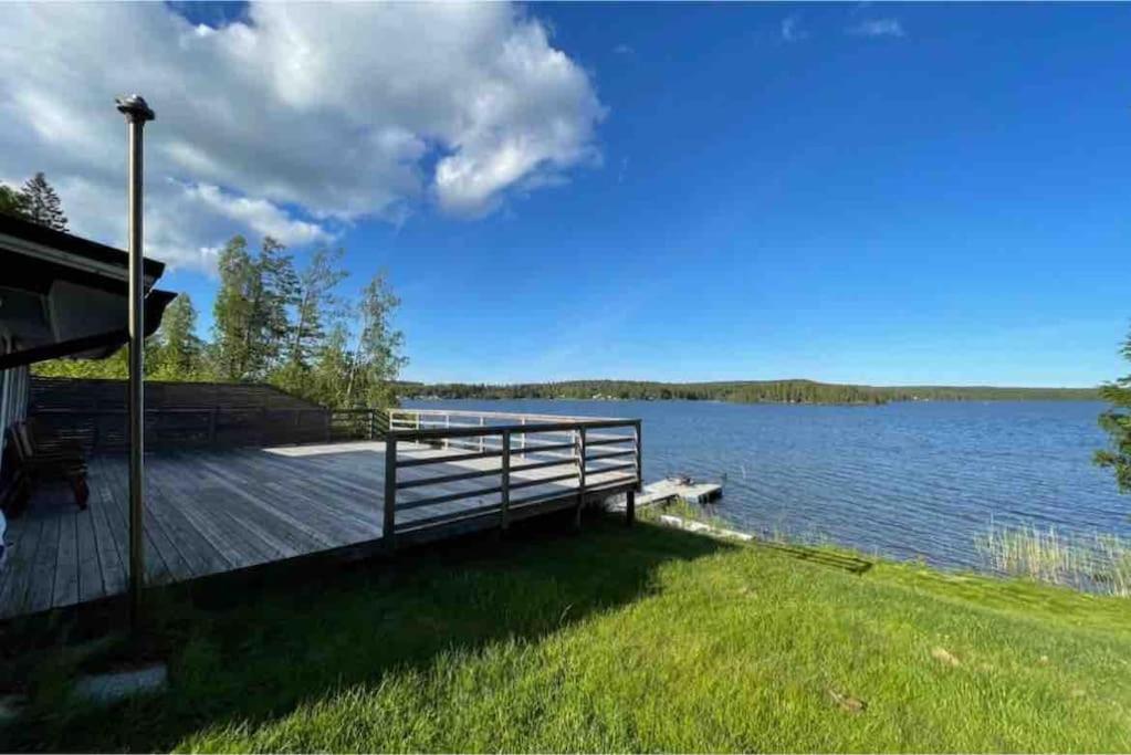 a dock with a view of a lake at 3 bedroom lakehouse with private bridge and garden in Sundsvall