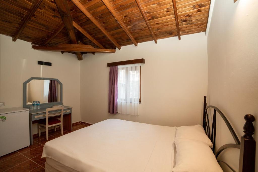 Postel nebo postele na pokoji v ubytování Yakamoz Hotel Gökçeada