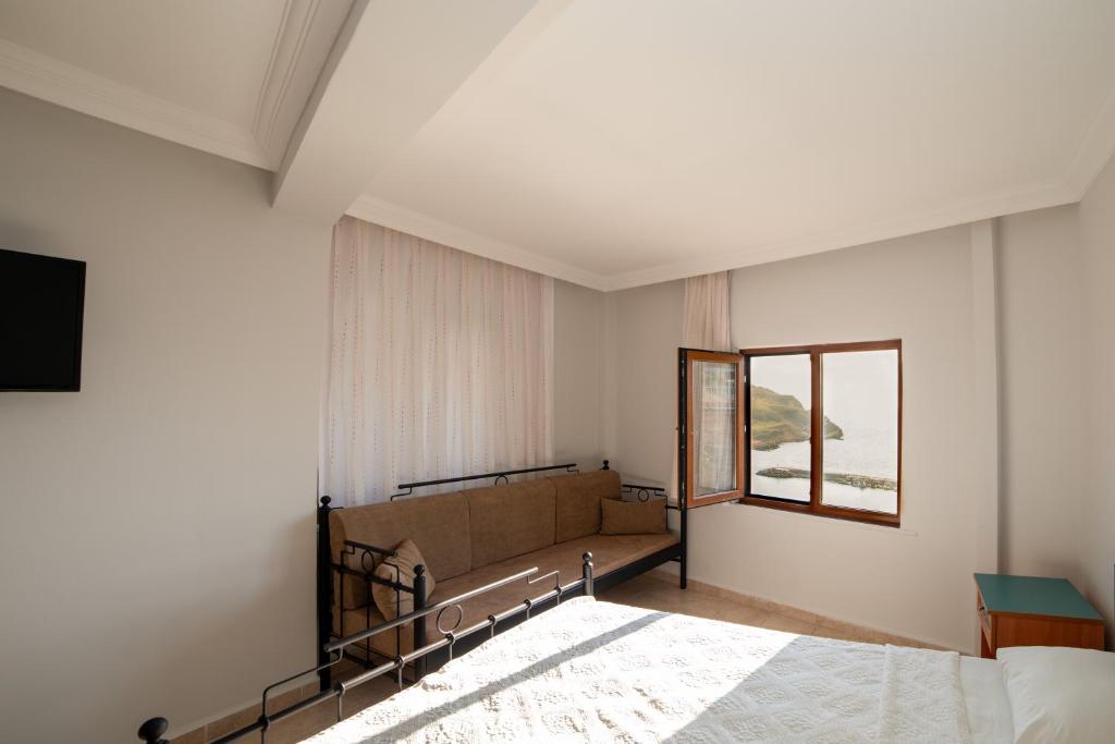 Postel nebo postele na pokoji v ubytování Yakamoz Hotel Gökçeada