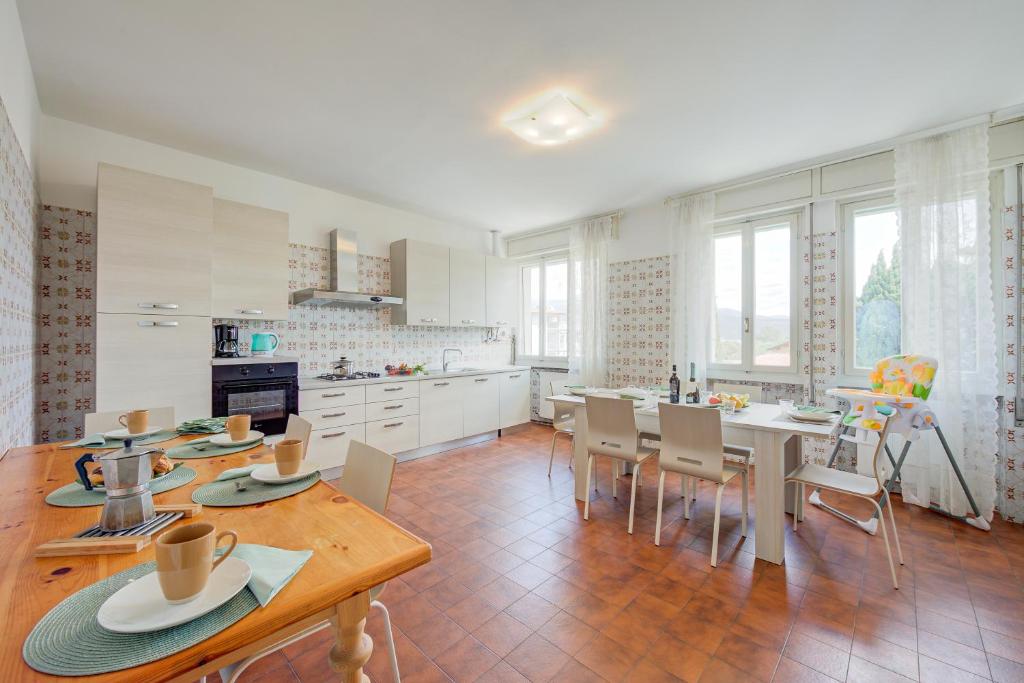 a kitchen with a table and chairs and a dining room at Margherita near lake-child friendly - Happy Rentals in Toscolano Maderno