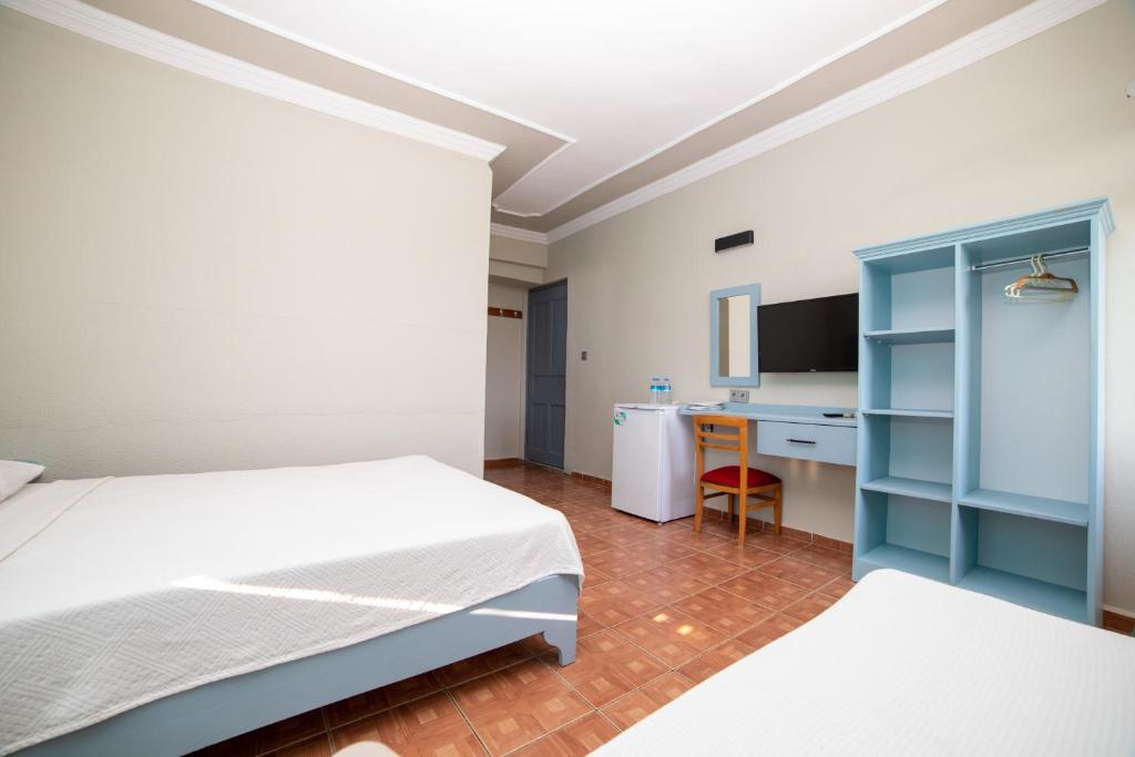 Postel nebo postele na pokoji v ubytování Yakamoz Hotel Gökçeada