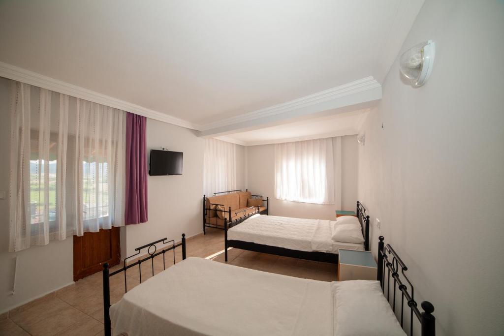 Postel nebo postele na pokoji v ubytování Yakamoz Hotel Gökçeada