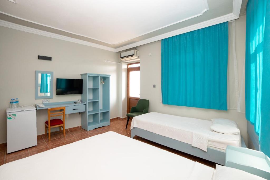 Postel nebo postele na pokoji v ubytování Yakamoz Hotel Gökçeada