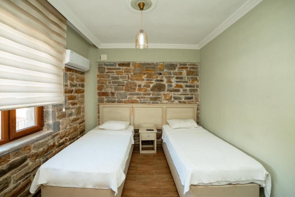 Postel nebo postele na pokoji v ubytování Yakamoz Hotel Gökçeada