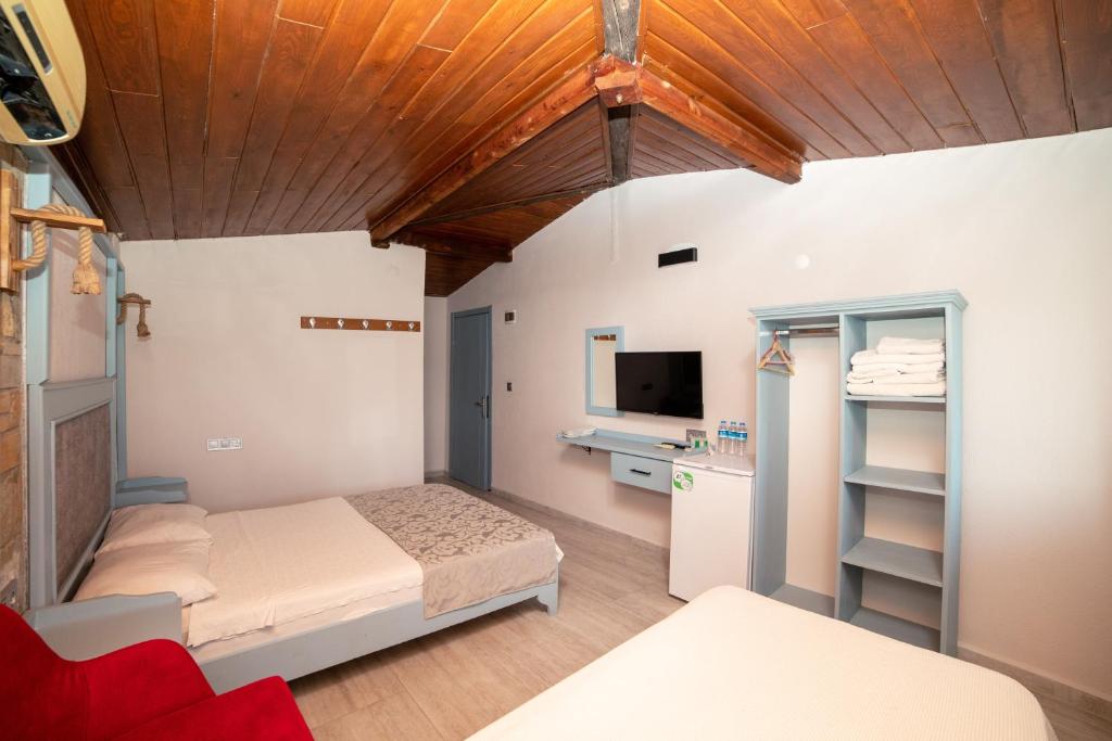 Postel nebo postele na pokoji v ubytování Yakamoz Hotel Gökçeada