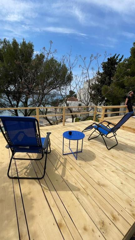 two chairs and a table on a wooden deck at Villa Renata in Pirovac