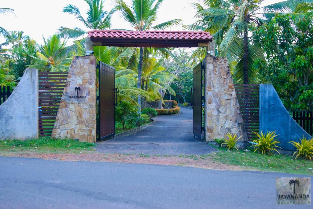 an entrance to a driveway with a gate at Jayananda Estate Villa in Dickwella