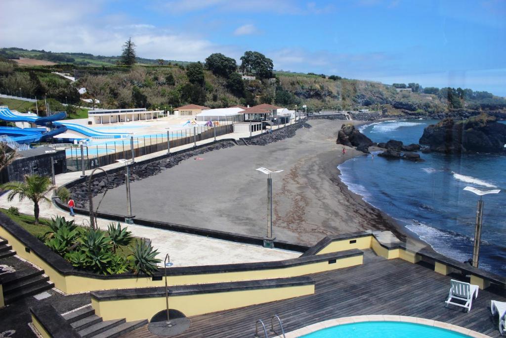 a view of a beach with a swimming pool at Vinha da Areia Beach Hotel in Vila Franca do Campo