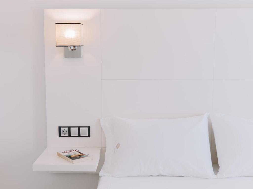 Posteľ alebo postele v izbe v ubytovaní Hostal Las Gaviotas del Cabo