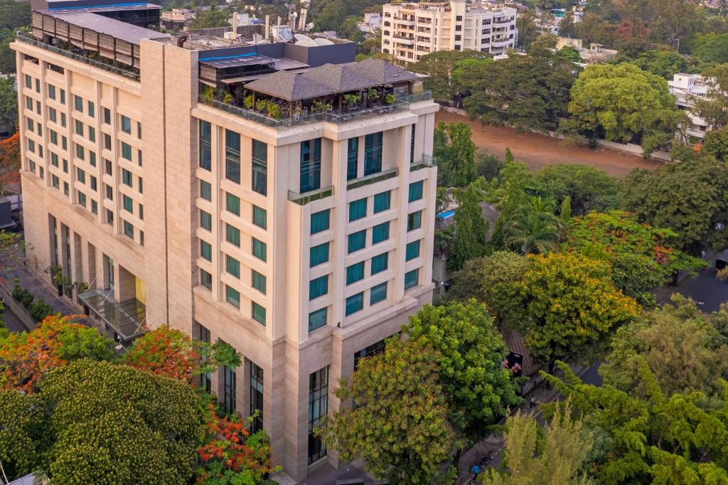 an overhead view of a tall white building at O Hotel Pune in Pune