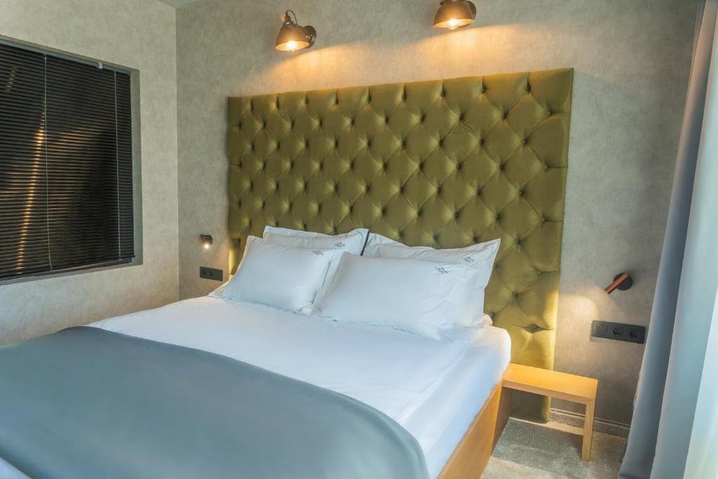 A bed or beds in a room at The LODGE Hotel