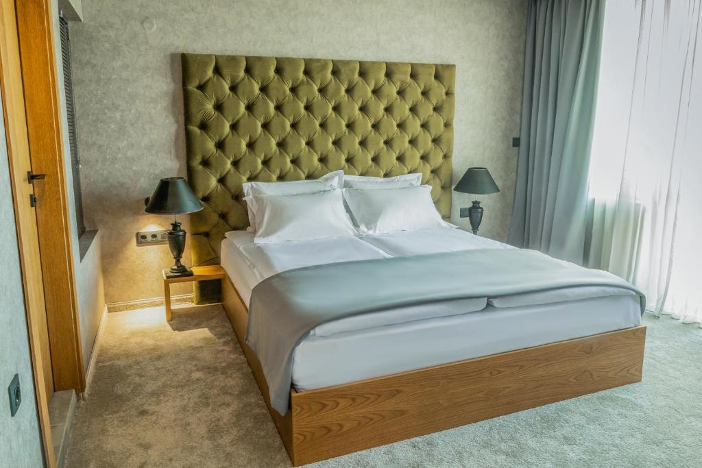 A bed or beds in a room at The LODGE Hotel