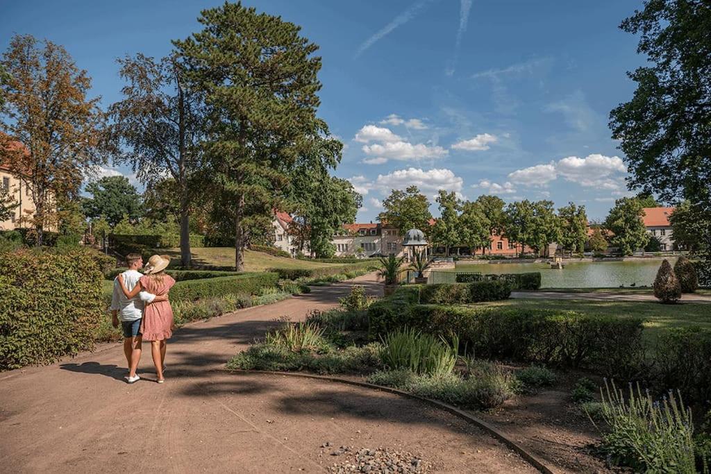 a man and a woman standing on a path in a park at Traumhafte Auszeit in Bad Lauchstädt