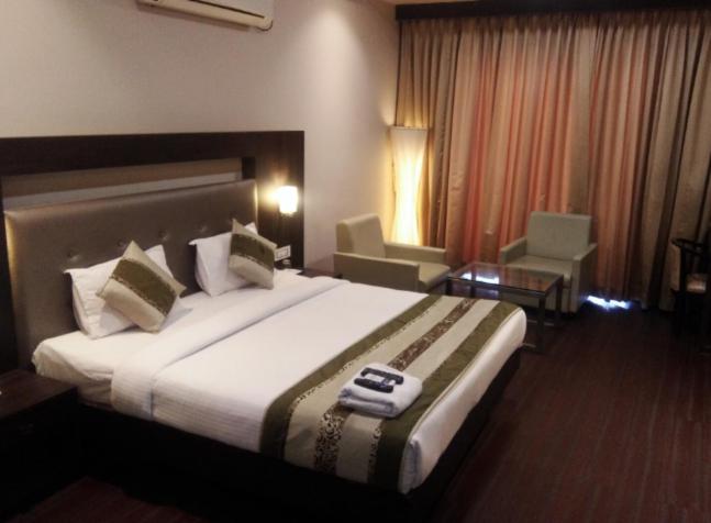 a bedroom with a large bed in a hotel room at Hotel Signature in Ichalkaranji