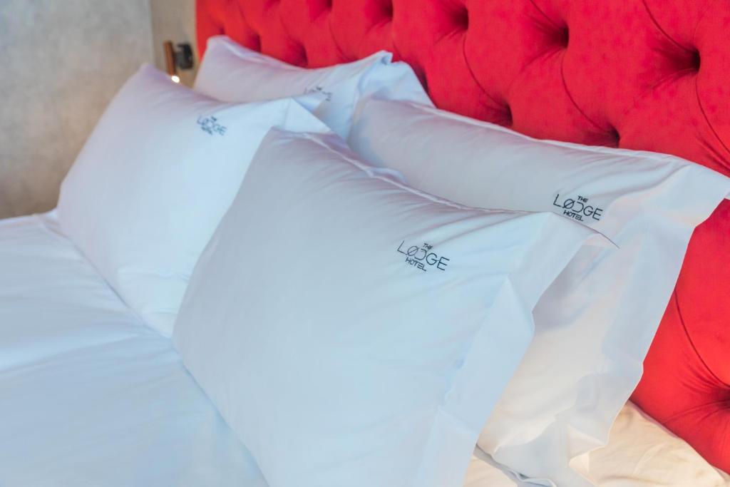 A bed or beds in a room at The LODGE Hotel