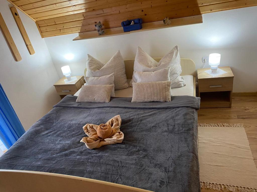 a bedroom with a large bed with a towel on it at Privát RIA in Pavlova Ves
