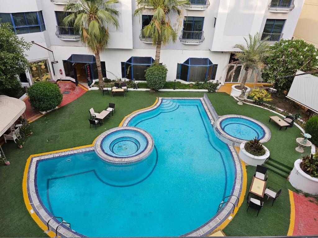 an overhead view of a swimming pool in a courtyard at Majestic Hotel in Manama