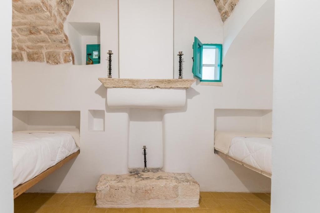 A bed or beds in a room at Masseria Bel Cortile - Ostuni