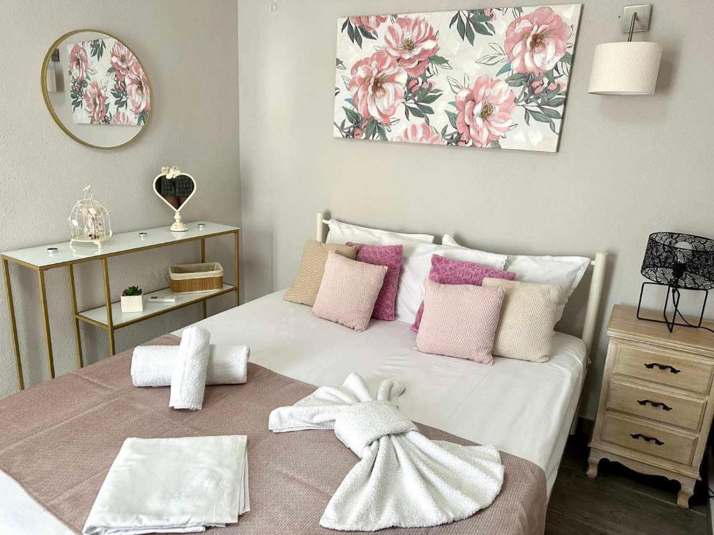 a bedroom with a bed with pink and white pillows at ENDLESS BLUE Dream Villa in Paleo Tsifliki