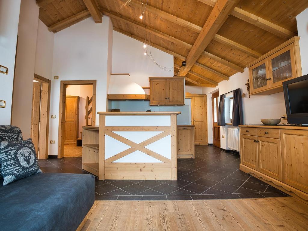 a kitchen with a barn door in a room at Aparthotel Monte 44 in Selva di Val Gardena
