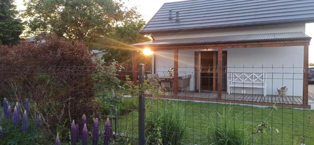 a house with a fence in front of a yard at Piękne Zielone in Zator