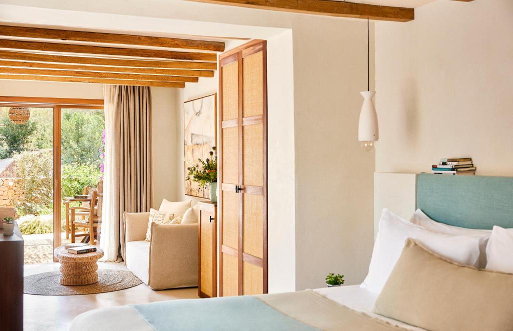 a bedroom with a bed and a door to a patio at Teranka in Playa Migjorn