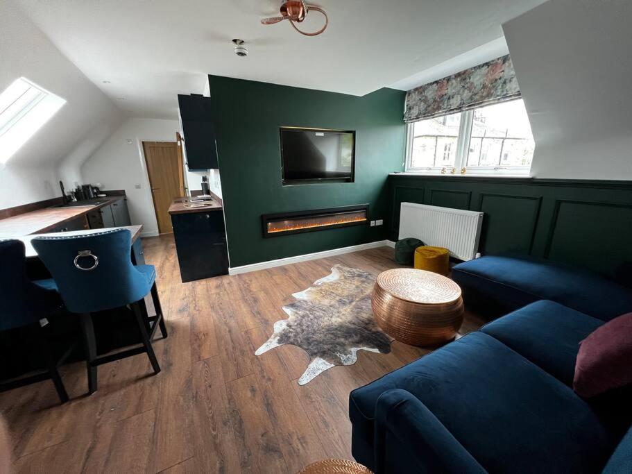 a living room with a couch and a table at Roslin Templar loft in Roslin
