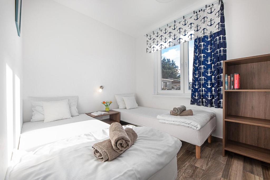 Postel nebo postele na pokoji v ubytování Chłopy Beach Resort - domki letniskowe i apartamenty