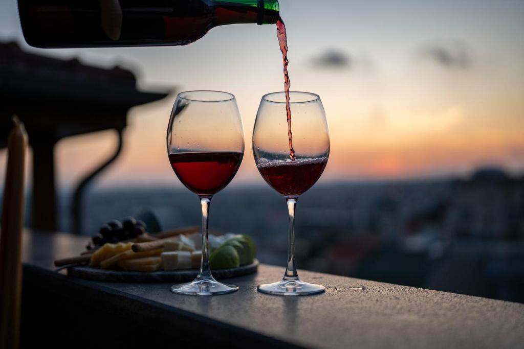 two glasses of wine are sitting on a table at Pera Luna Premium Hotel in Istanbul