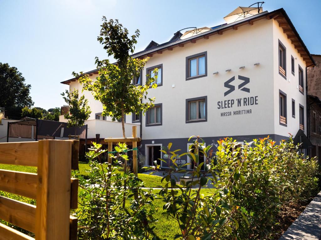 un edificio con un cartello che legge villaggio del sonno di SLEEP 'N' RIDE Massa Marittima a Massa Marittima