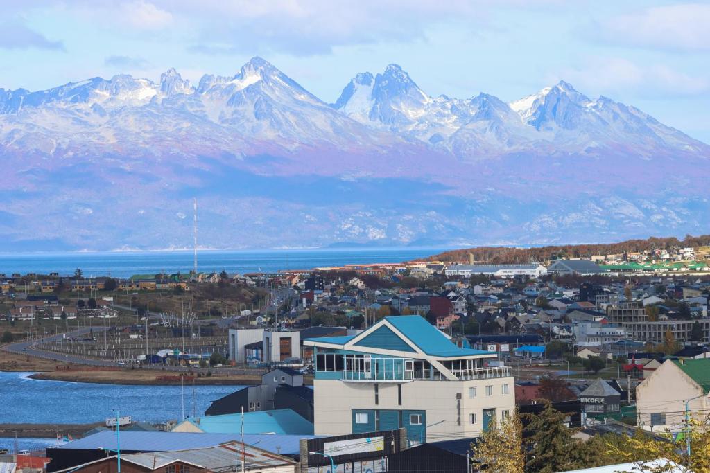 a city with snow capped mountains in the background at Alto Andino Hotel in Ushuaia