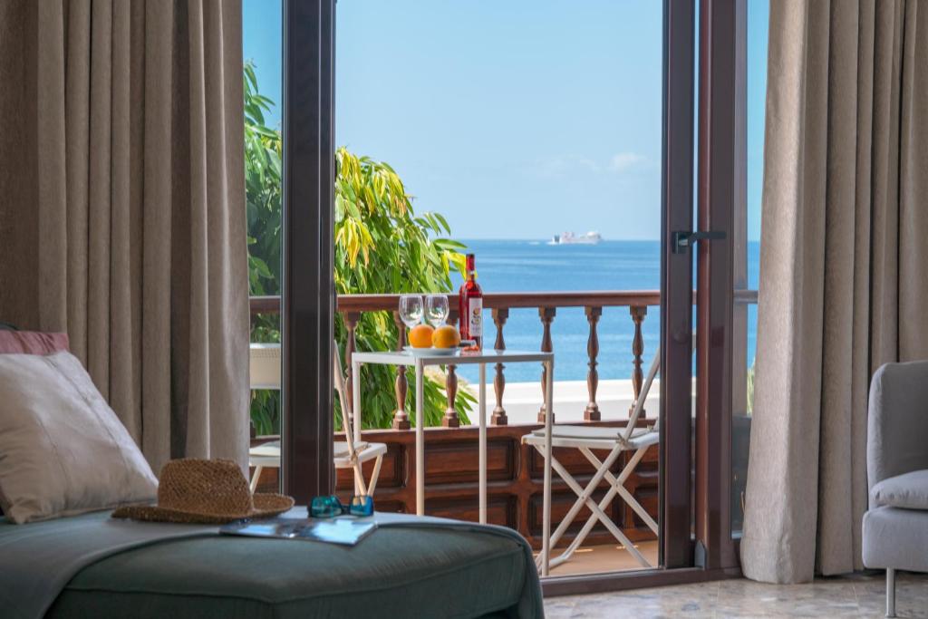 a living room with a balcony with a view of the ocean at Santa Rosa La Peñita (Puerto del Carmen) in Puerto del Carmen