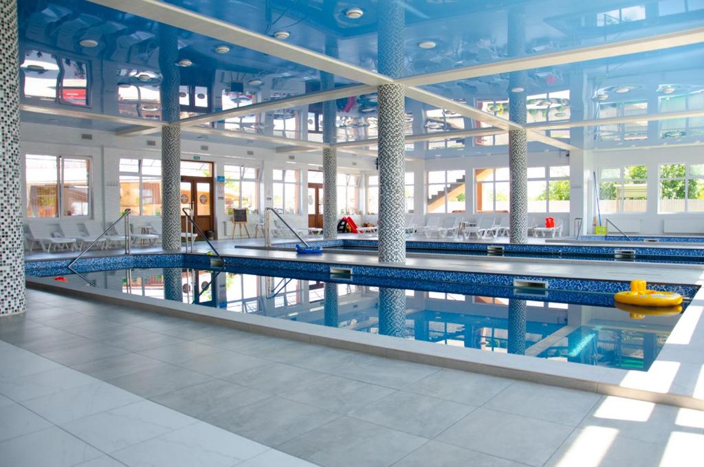a large swimming pool in a large building at Hotel VIZA in Solotvyno