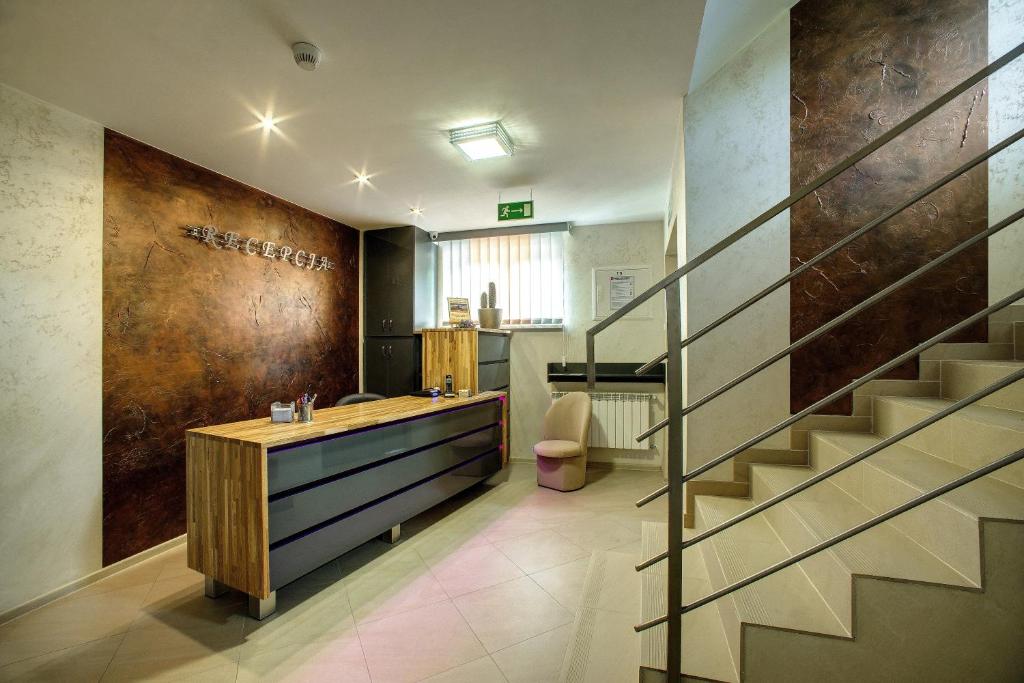 a lobby with a staircase and a reception desk at Zajazd Sanocki in Sanok