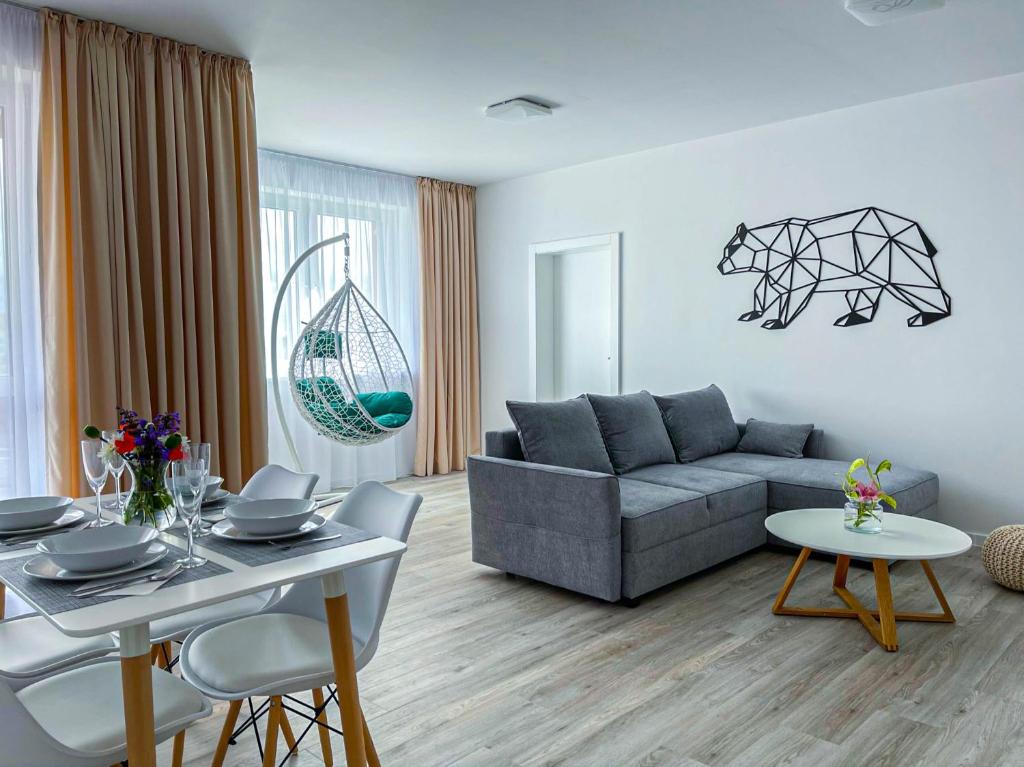 a living room with a couch and a table at LAWIS Apartments in Poprad