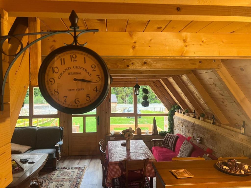 a large clock hanging from the ceiling of a room at Vikendica GORSKI VUK Jelovica in Berane