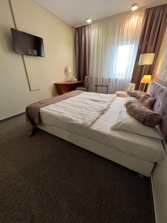Postel nebo postele na pokoji v ubytování Astra Hotel