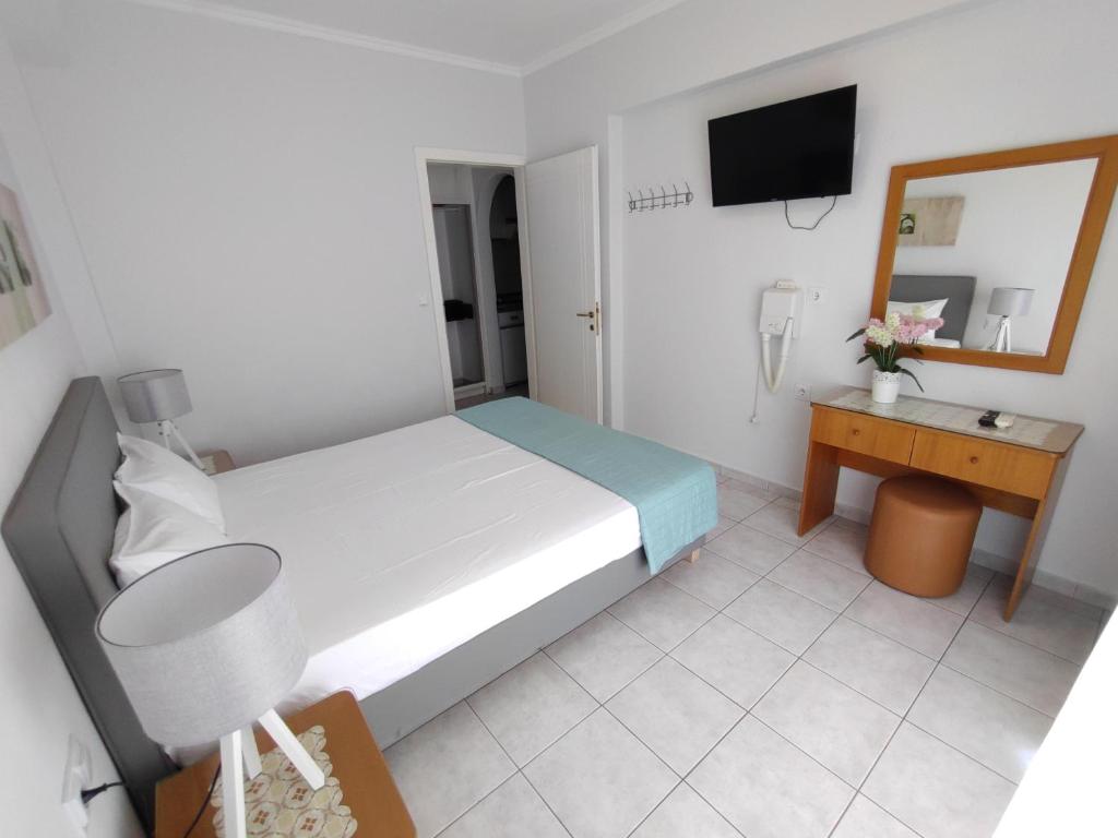 Postel nebo postele na pokoji v ubytování Ioli Apartments