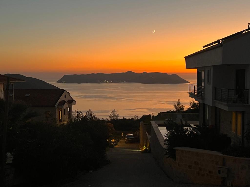 a view of the ocean at sunset from a house at Meri Suite Apart Kaş in Kaş