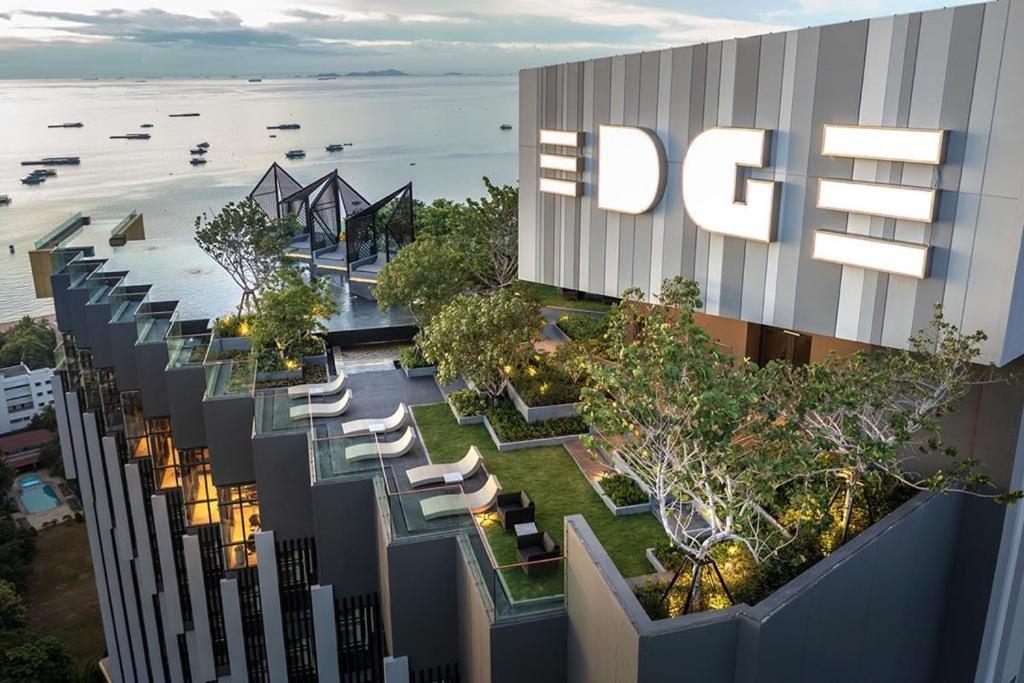 an overhead view of a building with trees and chairs at Condo Edge Central in Pattaya