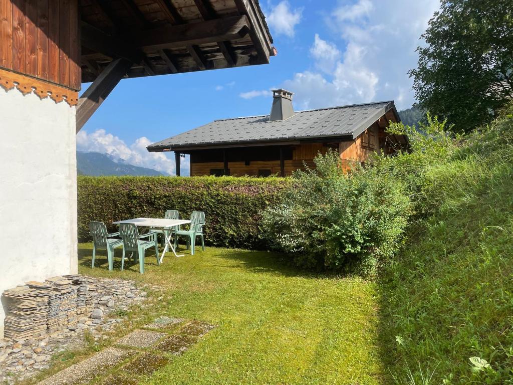 a table and chairs in front of a house at Chalet Chez Gaby 2 in Morzine