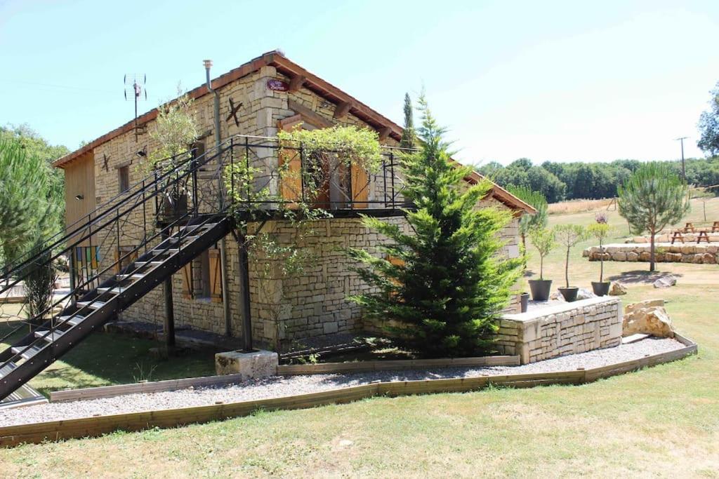 a brick house with a staircase in front of it at Gîte Le Buron in Chazelles