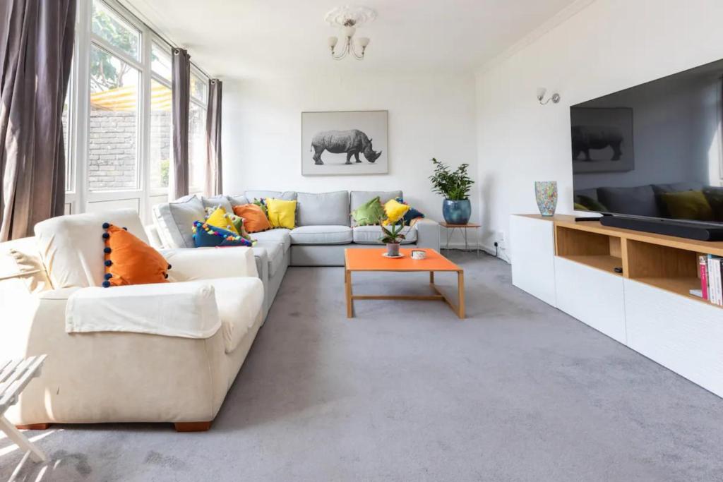a living room with a couch and a table at Spacious & Welcoming 4BD House - Kennington in London